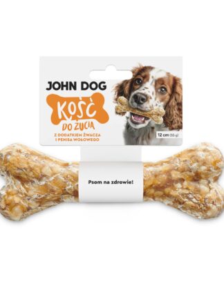 Kość do żucia 17 cm z dodatkiem żwacza i penisa wołowego w kolorze beżowym– widok od przodu. Na środku kości znajduje się biała owijka, do której przymocowana jest biała etykieta z pomarańczowym napisem. Po prawej na etykiecie jest pies rasy mieszanej, który trzyma kość w zębach.