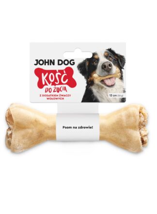 Kość do żucia 12 cm z dodatkiem żwaczy wołowych w kolorze beżowym– widok od przodu. Na środku kości znajduje się biała owijka, do której przymocowana jest biała etykieta z czerwonym napisem. Po prawej na etykiecie jest pies rasy berneńczyk, który trzyma kość w zębach.