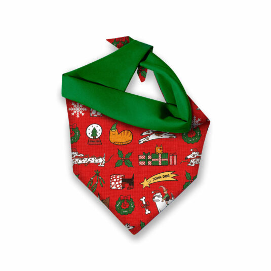 Zdjęcie złożonej apaszki dla psa w świąteczny wzór. Dominują kolory czerwony i zielony.