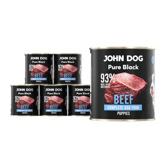 Karma mokra dla szczeniąt z wołowiny John Dog Pure Black w sześciu czarnych puszkach 800g. Na etykietach jest surowe mięso z wołowiny, zdjęcie psa oraz białe i niebieskie napisy.