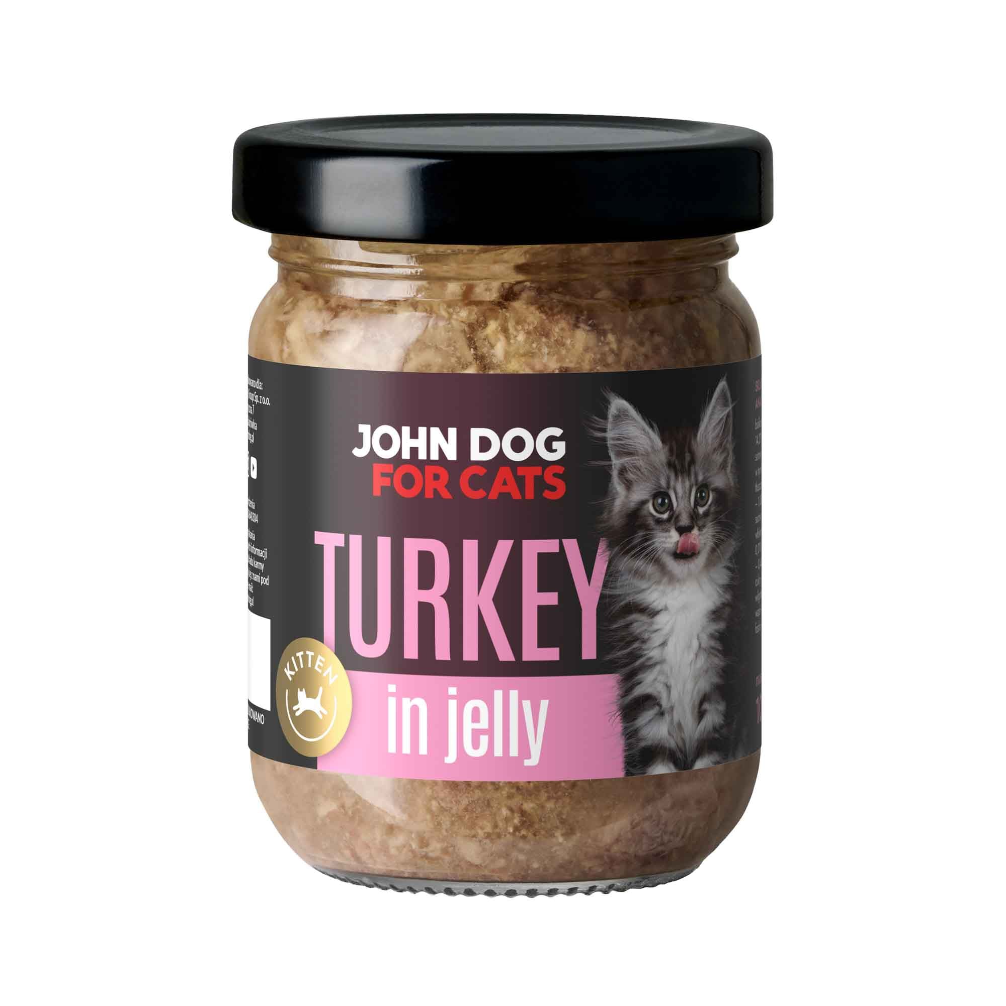 Słoik mokrej karmy z czarnym wieczkiem dla kociąt John Dog for Cats o smaku indyka, w galaretce. Na ciemnej etykiecie widoczny jest szary pasiasty kot i różowe napisy.