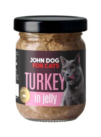 Słoik mokrej karmy z czarnym wieczkiem dla kotów John Dog for Cats o smaku indyka, w galaretce. Na ciemnej etykiecie widoczny jest szary kot i różowe napisy.