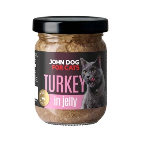 Słoik mokrej karmy z czarnym wieczkiem dla kotów John Dog for Cats o smaku indyka, w galaretce. Na ciemnej etykiecie widoczny jest szary kot i różowe napisy.
