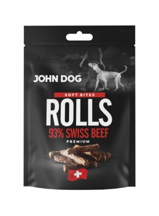 Czarne opakowanie przysmaków dla psów John Dog Rolls Soft Bites Premium-kawałki zawierające 95% mięsa z wołowiny. Na opakowaniu znajduje się zdjęcie psa obok człowieka, grafika suszonych podłużnych kawałków mięsa oraz symbol szwajcarskiej flagi.