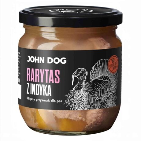 Mały słoik rarytasów John Dog z czarnym wieczkiem i czarną etykietą. Na etykiecie ilustracja indyka. W słoiku widać kawałki mięsa.